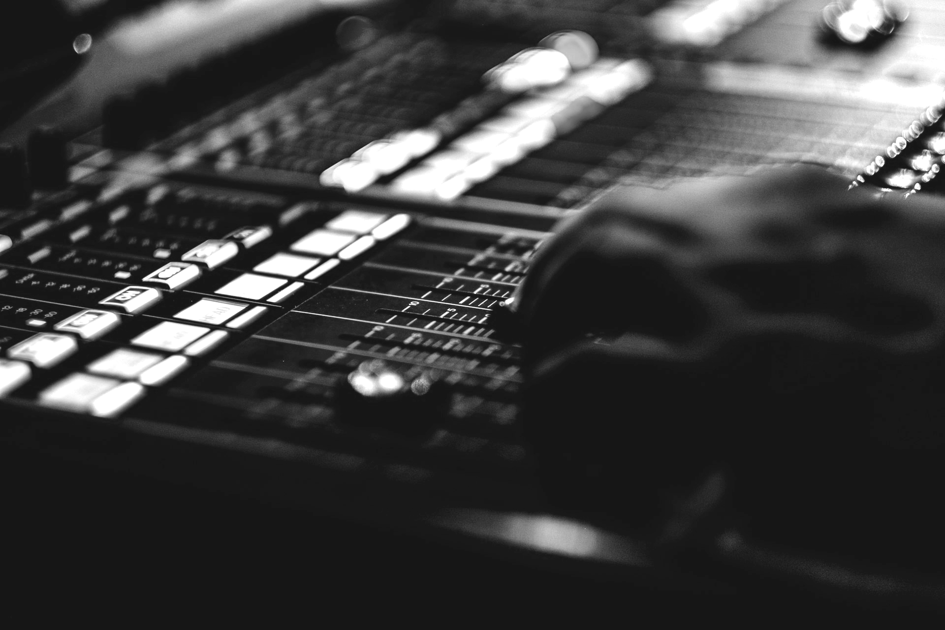 person's hand on black audio mixer